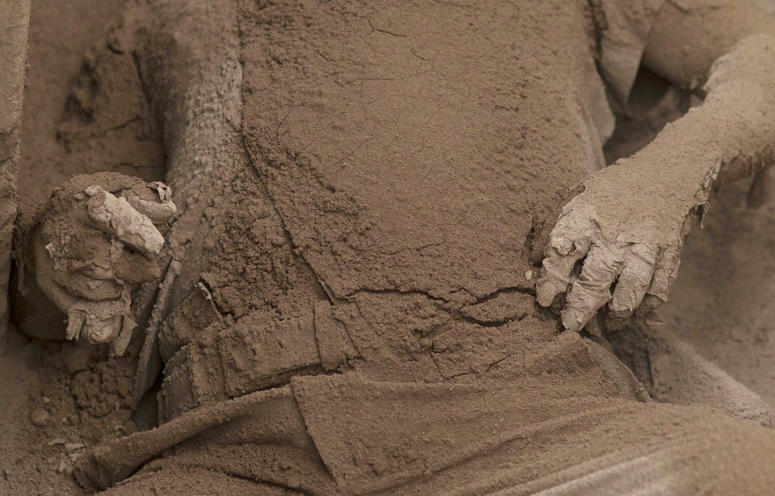 The body of a victim is covered in volcanic ash spewed by the Volcan de Fuego. The body of a victim is covered in volcanic ash spewed by the Volcan de Fuego.