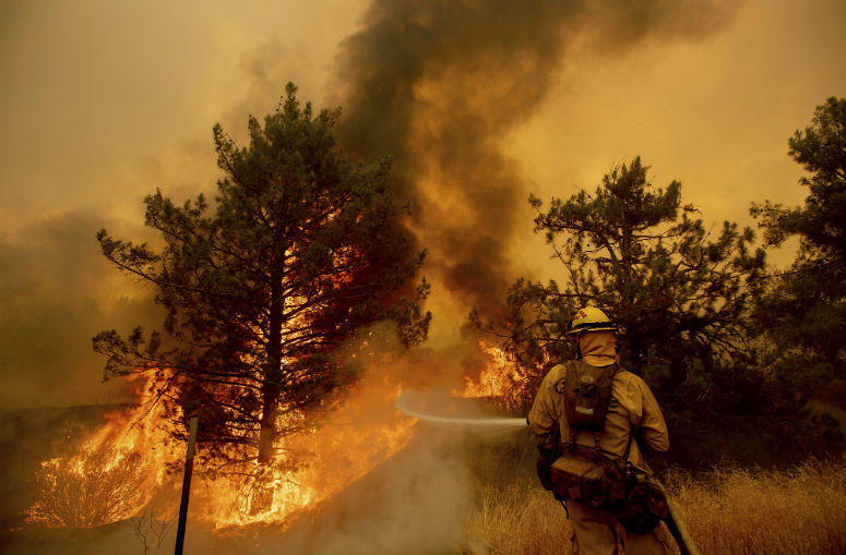 A firefighter scrambles to stop the Pawnee fire as it spots across Highway 20 near Clearlake Oaks, Calif., on Sunday, July 1, 2018. A firefighter scrambles to stop the Pawnee fire as it spots across Highway 20 near Clearlake Oaks, Calif., on Sunday, July 1, 2018.