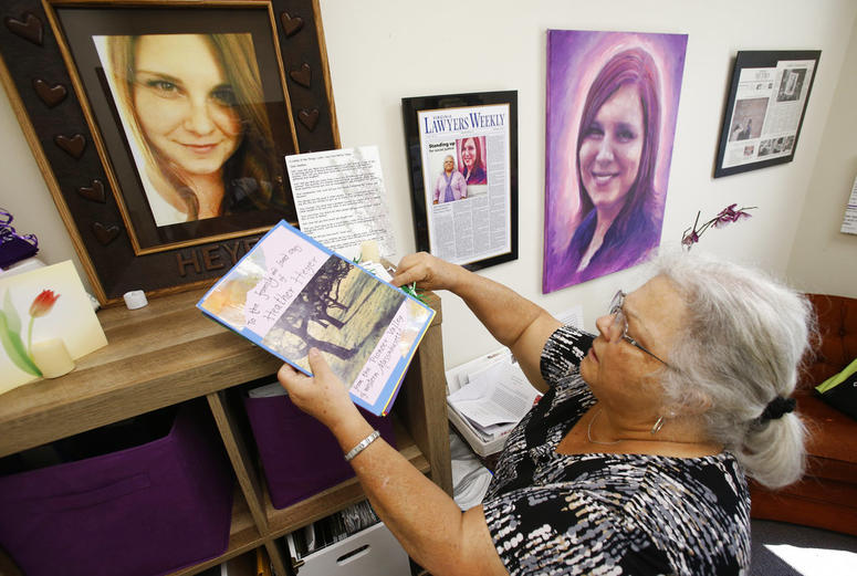 In this Monday, Aug. 6, 2018 photo, Susan Bro, mother of Heather Heyer, who was killed during the Unite the Right rally last year, looks over memorabilia in her office in Charlottesville, Va. In this Monday, Aug. 6, 2018 photo, Susan Bro, mother of Heather Heyer, who was killed during the Unite the Right rally last year, looks over memorabilia in her office in Charlottesville, Va.