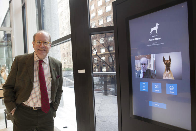 This Wednesday, Jan. 9, 2019, photo shows American Kennel Club Museum of the Dog's Executive Director Alan Fausel smiling after finding his dog breed match at the Find Your Match interactive kiosk during a tour of the museum in New York. American Kennel Club Museum of the Dog's Executive Director Alan Fausel smiling after finding his dog breed match at the Find Your Match interactive kiosk.