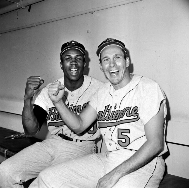 In this Oct. 5, 1966, file photo, Baltimore Orioles teammates Frank Robinson, left, and Brooks Robinson pose after leading the Baltimore Orioles to a 5-2 win in the opening game of the World Series against the Los Angeles Dodgers, in Los Angeles. Frank Robinson (left) and Brooks Robinson, Oct. 5, 1966
