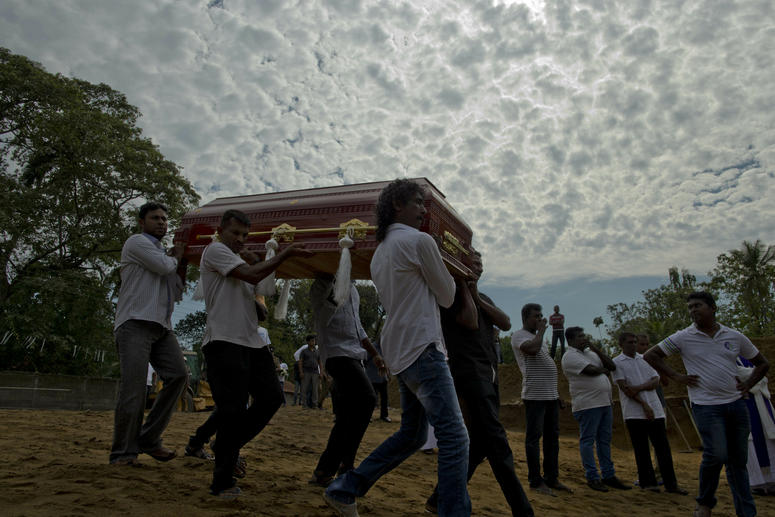Relatives carry a coffin for burial during a mass burial for Easter Sunday bomb blast victims in Negombo, Sri Lanka, Wednesday, April 24, 2019. A mass burial for victims in Sri Lanka.