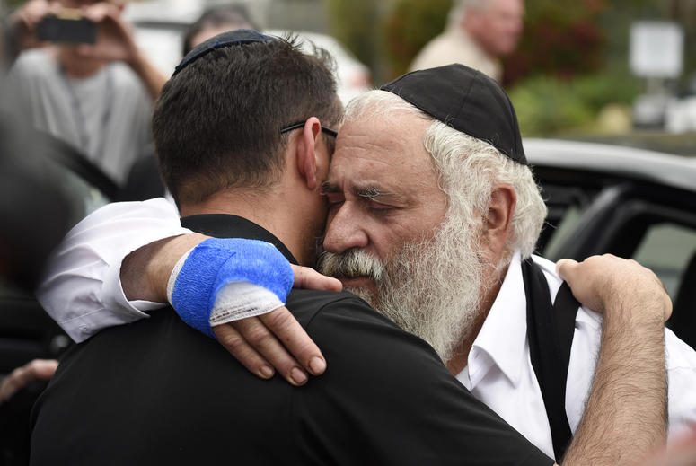 Rabbi Yisroel Goldstein, right, is hugged as he leaves a news conference at the Chabad of Poway synagogue, Sunday, April 28, 2019, in Poway, Calif. Poway, California synagogue shooting