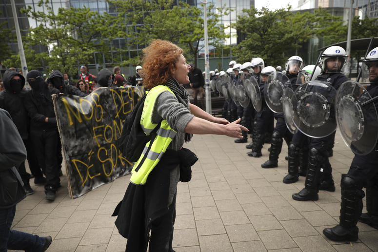 A yellow vest protestor talks to a line of police officers during a demonstration in Brussels, Sunday, May 26, 2019. The demonstration took place as Belgium took to the polls to elect regional, national and European candidates. A yellow vest protestor talks to a line of police officers during a demonstration in Brussels, Sunday, May 26, 2019. The demonstration took place as Belgium took to the polls to elect regional, national and European candidates.