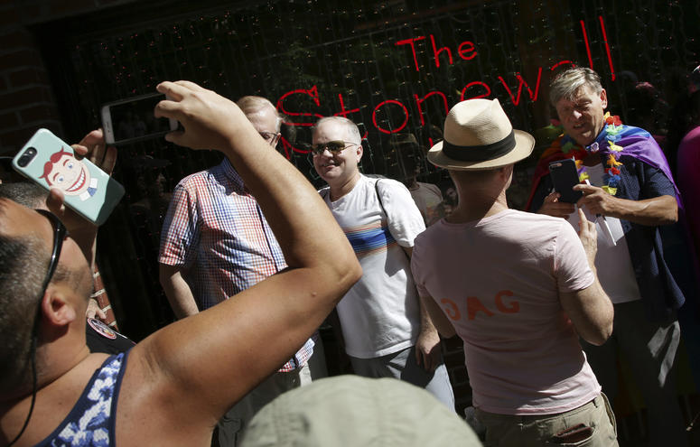 People pose for pictures in front of the Stonewall Inn before the start of the Queer Liberation March in New York, Sunday, June 30, 2019. People pose for pictures in front of the Stonewall Inn before the start of the Queer Liberation March in New York, Sunday, June 30, 2019.