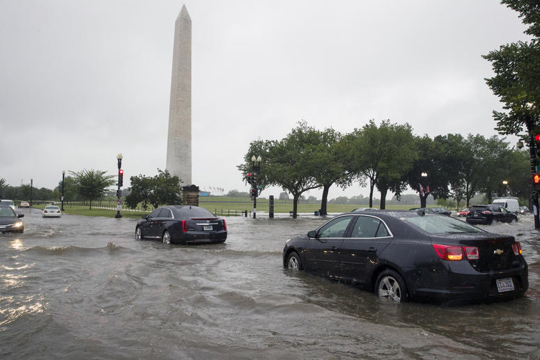 Heavy rainfall flooded the intersection of 15th Street and Constitution Ave., NW stalling cars in the street, Monday, July 8, 2019, in Washington near the Washington Monument. Flooding