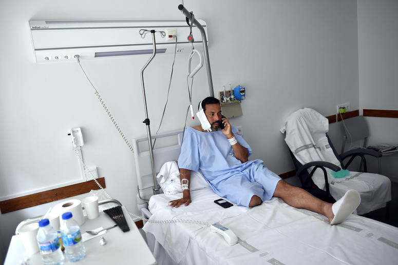 Jaime Alvarez from Santa Clara County, California, sits in a hospital in Pamplona, northern Spain, Monday, July 8, 2019 after being gored by a bull Sunday at the San Fermin Festival. Jaime Alvarez