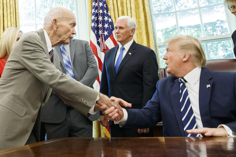 President Donald Trump shakes hands with Apollo 11 astronaut Michael Collins, left, with Vice President Mike Pence, during a photo opportunity commemorating the 50th anniversary of the Apollo 11 moon landing, in the Oval Office of the White House, Friday, President Donald Trump shakes hands with Apollo 11 astronaut Michael Collins, left, with Vice President Mike Pence, during a photo opportunity commemorating the 50th anniversary of the Apollo 11 moon landing, in the Oval Office of the White House, Friday,