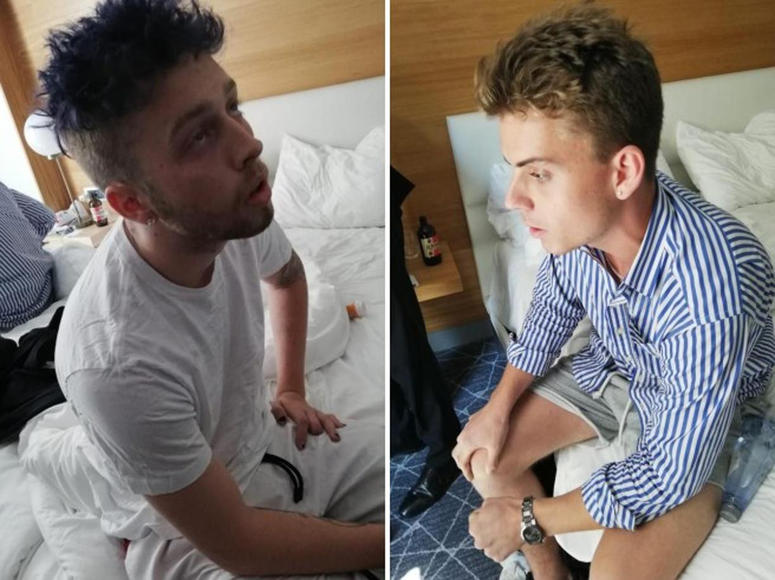 In this combo photo released by Italian Carabinieri, Gabriel Christian Natale Hjorth, right, and Finnegan Lee Elder, sit in their hotel room in Rome. Gabriel Christian Natale Hjorth, right, and Finnegan Lee Elder