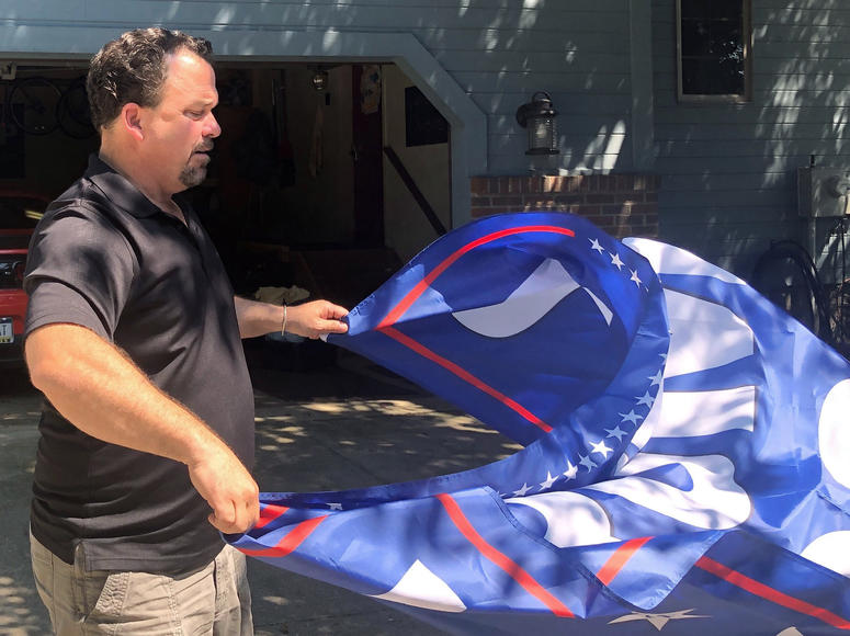 He cheered Trump on when he tweeted about Rep. Elijah Cummings district anchored in Baltimore. Through Nolan's lens, Trump's message wasn't racist, it was truth. In this July 31, 2019, photo, Jim Noland unspools a Trump flag near Erie, Pa.
