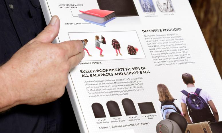 Steve Naremore, founder and CEO of TuffyPacks, notes the use and various options of his bulletproof inserts on the packaging of the product that can be placed into various makes and sizes of backpacks, during a demonstration at the Shiloh Shooting Range. Bullet-resistant backpacks