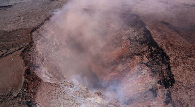 In this photo released by U.S. Geological Survey, a plume of ash rises from the Puu Oo vent on Hawaii's Kilaueaa Volcano Thursday, May 3, 2018 in Hawaii Volcanoes National Park. a plume of ash rises from the Puu Oo vent on Hawaii's Kilaueaa Volcano