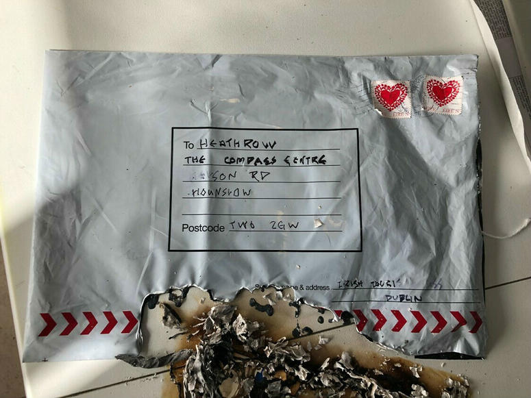 In this photo dated Tuesday March 5, 2019, issued by Britain's Metropolitan Police showing a suspect package after it ignited, sent to Heathrow airport. In this photo dated Tuesday March 5, 2019, issued by Britain's Metropolitan Police showing a suspect package after it ignited, sent to Heathrow airport.