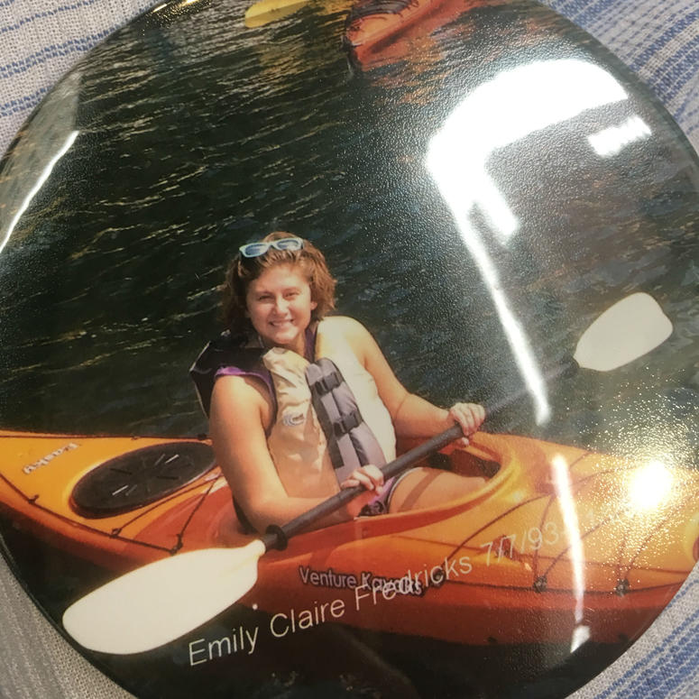 An image of Emily Fredricks on a button is shown worn by her mother, Laura. An image of Emily Fredricks on a button is shown worn by her mother, Laura.