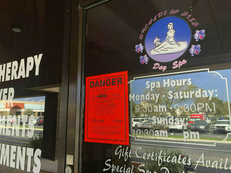 In this Feb. 19, 2019, file photo, a sign is posted outside of Orchids of Asia Day Spa in Jupiter, Fla., one of several spas closed in south Florida as a result of a six-month investigation into sex trafficking. In this Feb. 19, 2019, file photo, a sign is posted outside of Orchids of Asia Day Spa in Jupiter, Fla., one of several spas closed in south Florida as a result of a six-month investigation into sex trafficking.