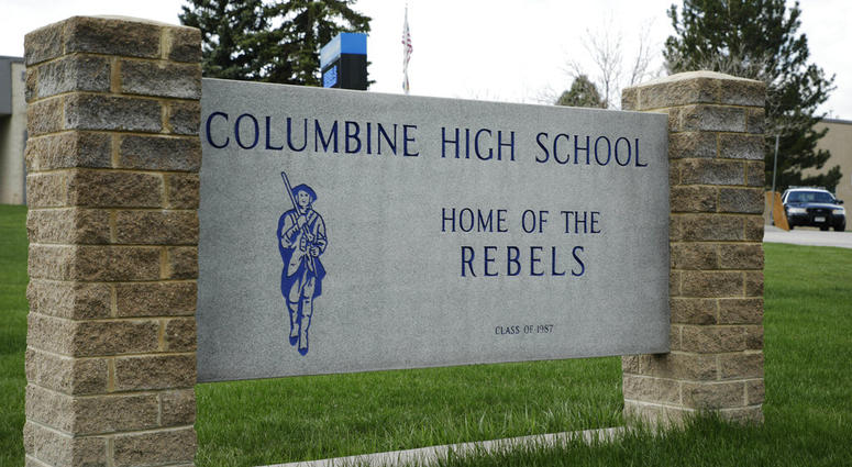 A patrol car is parked in front of Columbine High School, Wednesday, April 17, 2019, in Littleton, Colo., where two student killed 12 classmates and a teacher in 1999. columbine