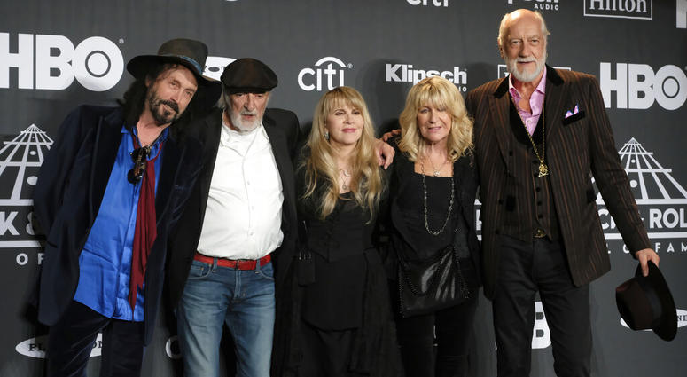 This March 29, 2019 file photo shows Inductee Stevie Nicks, center, posing with other members of Fleetwood Mac, from left, Mike Campbell, John McVie, Christine McVie and Mick Fleetwood at the Rock & Roll Hall of Fame induction ceremony in New York. Fleetwood Mac