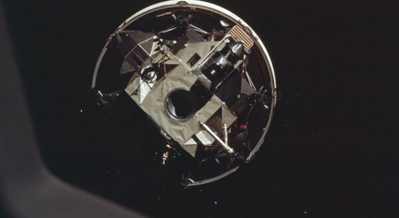 The Apollo 11 crew docks head-first with the moon landing module. The Apollo 11 crew docks head-first with the moon landing module.