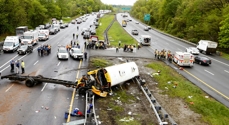 Emergency personnel examine a school bus after it collided with a dump truck, injuring multiple people, on Interstate 80 in Mount Olive, N.J. Emergency personnel examine a school bus after it collided with a dump truck, injuring multiple people, on Interstate 80 in Mount Olive, N.J.