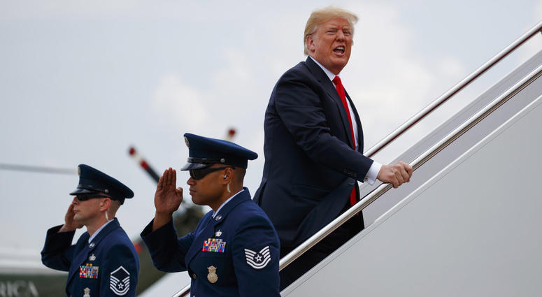 President Donald Trump yells to reporters as he boards Air Force One for a trip to New York to discuss immigration policy. President Donald Trump yells to reporters as he boards Air Force One for a trip to New York to discuss immigration policy.