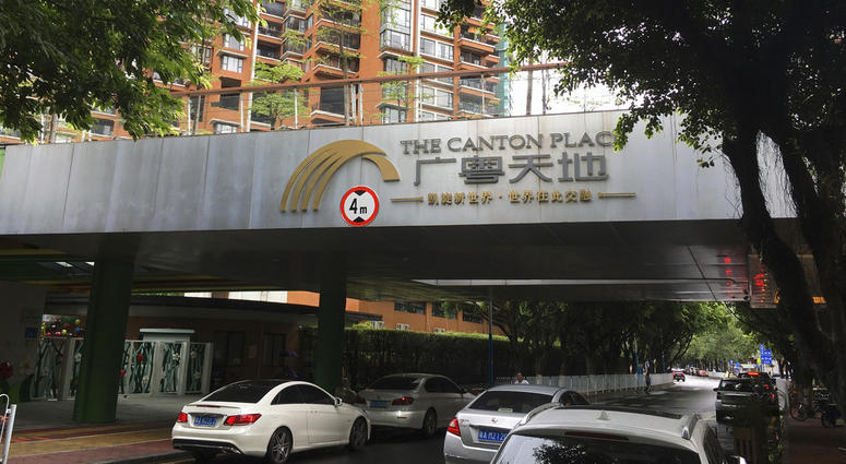 Vehicles pass by high-rise apartment buildings in The Canton Place where U.S. government workers experienced unexplained health issues in Guangzhou. Vehicles pass by high-rise apartment buildings in The Canton Place where U.S. government workers experienced unexplained health issues in Guangzhou.