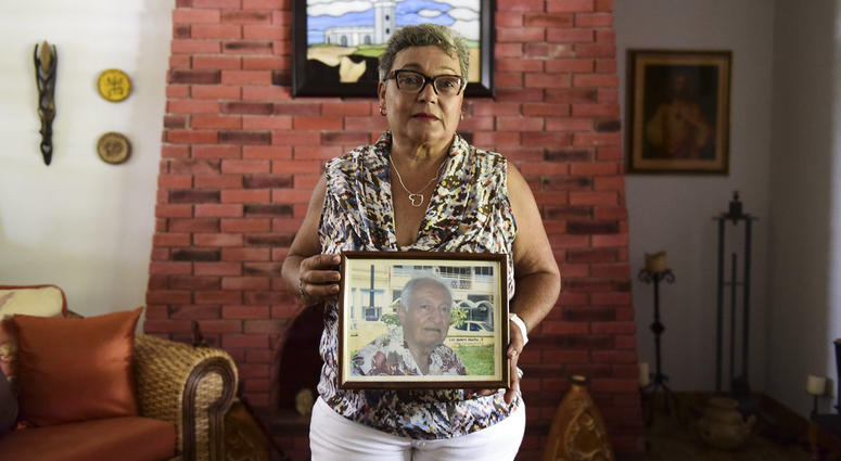 Nerybelle Perez poses with a portrait of her father, World War II veteran Efrain Perez, who died inside an ambulance after being turned away from the largest public hospital when it had no electricity or water, days after Hurricane Maria passed. Nerybelle Perez poses with a portrait of her father, World War II veteran Efrain Perez, who died inside an ambulance after being turned away from the largest public hospital when it had no electricity or water, days after Hurricane Maria passed.