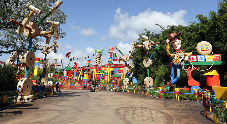 A statue of the character Sheriff Woody, right, greets visitors at the entrance Toy Story Land in Disney's Hollywood Studios at Walt Disney World in Lake Buena Vista, Fla. Toy Story Land