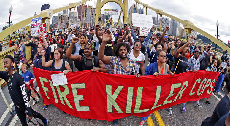 In this June 22, 2018, file photo, demonstrators protesting the fatal police shooting of Antwon Rose Jr. cross the Roberto Clemente Bridge during an evening rush hour march that began in downtown Pittsburgh. In this June 22, 2018, file photo, demonstrators protesting the fatal police shooting of Antwon Rose Jr. cross the Roberto Clemente Bridge during an evening rush hour march that began in downtown Pittsburgh.