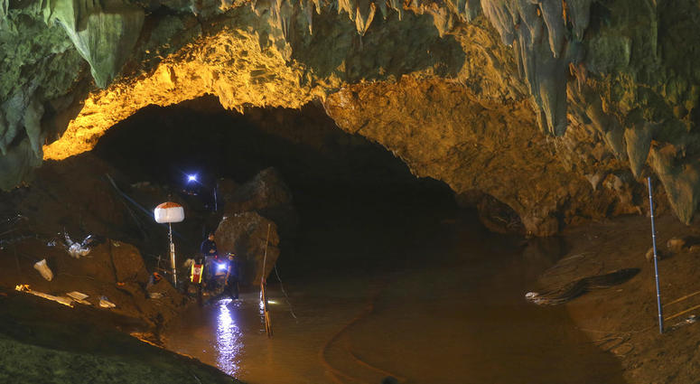 Rescuers talk each other during a search operation at the entrance to a cave complex where 12 soccer team members and their coach went missing, in Mae Sai, Chiang Rai province, in northern Thailand. Thailand Cave Search