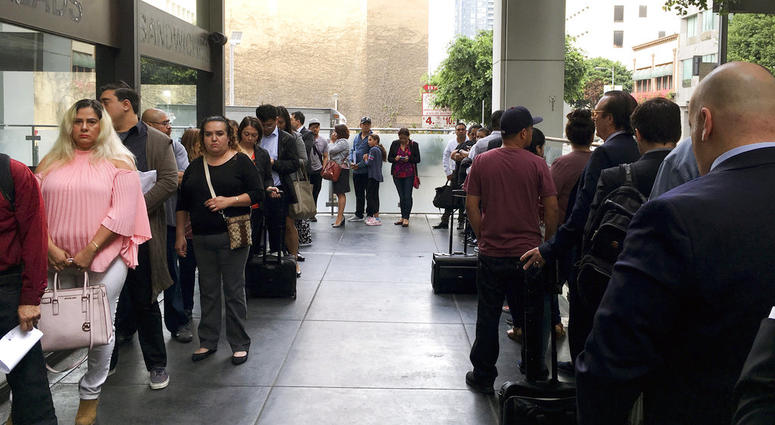 Immigrants awaiting deportation hearings line up outside the building that houses the immigration courts in Los Angeles. Immigrants awaiting deportation hearings line up outside the building that houses the immigration courts in Los Angeles.