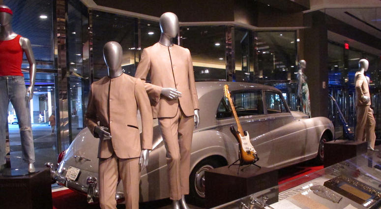Suits worn by the Beatles during an early tour of America in front of the Rolls Royce automobile owned by Elvis Presley, part of a large collection of music memorabilia on display at the Hard Rock casino in Atlantic City.