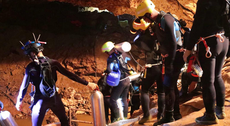 Thai rescue team members walk inside a cave where 12 boys and their soccer coach have been trapped since June 23, in Mae Sai, Chiang Rai province, northern Thailand. Thai rescue team members walk inside a cave where 12 boys and their soccer coach have been trapped since June 23, in Mae Sai, Chiang Rai province, northern Thailand.