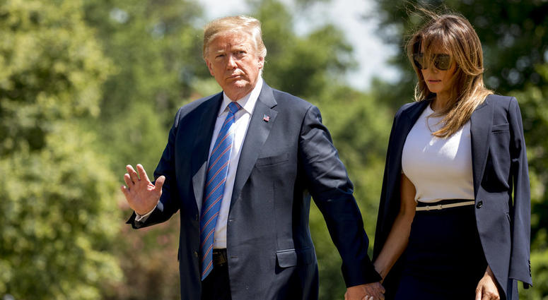 President Donald Trump, accompanied by first lady Melania Trump, waves to members of the media as they arrive on the South Lawn of the White House in Washington, Wednesday, July 18, 2018. President Donald Trump, accompanied by first lady Melania Trump, waves to members of the media as they arrive on the South Lawn of the White House in Washington, Wednesday, July 18, 2018.