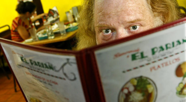 In this June 7, 2010 photo, Jonathan Gold, a food critic for L.A. Weekly, poses for a portrait at El Parian Restaurant in Los Angeles. Jonathan Gold