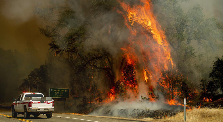 Flames from the Carr Fire lick above a Cal Fire truck in Whiskeytown, Calif., on Friday, July 27, 2018. Flames from the Carr Fire lick above a Cal Fire truck in Whiskeytown, Calif., on Friday, July 27, 2018.