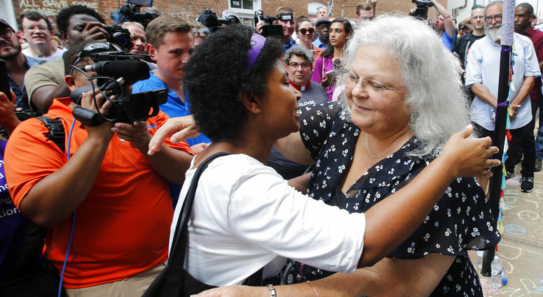 Susan Bro, right, mother of Heather Heyer who was killed during last year's Unite the Right rally, embraces a supporter after laying flowers at the spot her daughter was killed in Charlottesville, Va., Sunday, Aug. 12, 2018. Susan Bro, right, mother of Heather Heyer who was killed during last year's Unite the Right rally, embraces a supporter after laying flowers at the spot her daughter was killed in Charlottesville, Va., Sunday, Aug. 12, 2018.