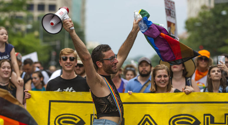 A man dances at the front of a counter-protest march on Pennsylvania Avenue towards the "Unite the Right 2" rally in Washington, Sunday, Aug. 12, 2018. A man dances at the front of a counter-protest march on Pennsylvania Avenue towards the "Unite the Right 2" rally in Washington, Sunday, Aug. 12, 2018.