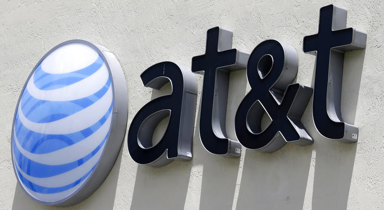 This July 27, 2017, file photo shows an AT&T logo at a store in Hialeah, Fla. AT&T