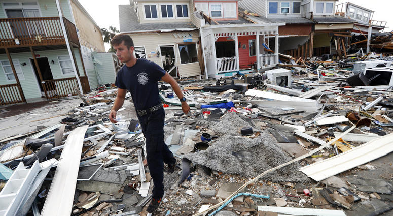 Firefighter Austin Schlarb performs a door to door search in the aftermath of Hurricane Michael in Mexico Beach, Fla., Thursday, Oct. 11, 2018. Firefighter Austin Schlarb performs a door to door search in the aftermath of Hurricane Michael in Mexico Beach, Fla., Thursday, Oct. 11, 2018.