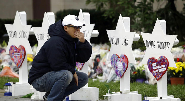 A person pauses in front of Stars of David with the names of those killed in a deadly shooting at the Tree of Life Synagogue, in Pittsburgh, Monday, Oct. 29, 2018. A person pauses in front of Stars of David with the names of those killed in a deadly shooting at the Tree of Life Synagogue, in Pittsburgh, Monday, Oct. 29, 2018.