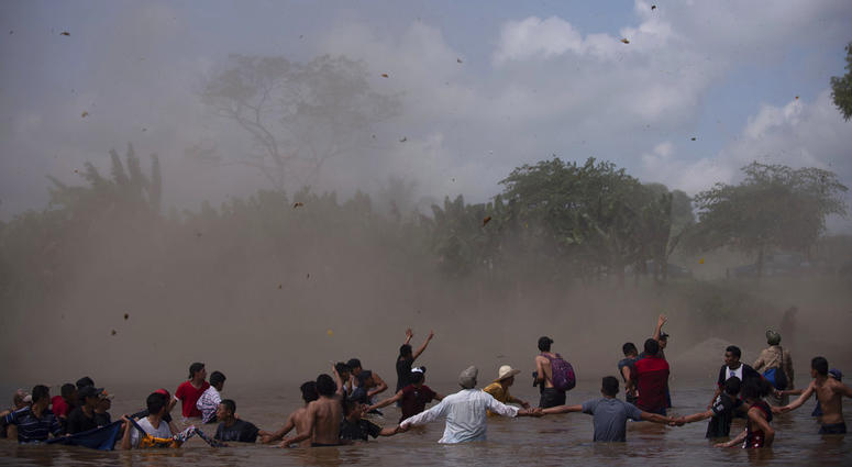Dust clouds are created by a Mexican Federal Police helicopter flying close to the Suchiate River that connects Mexico and Guatemala, in order to create a downwash force to discourage a new group of Central American migrants bound for the U.S border, in w Dust clouds are created by a Mexican Federal Police helicopter flying close to the Suchiate River that connects Mexico and Guatemala, in order to create a downwash force to discourage a new group of Central American migrants bound for the U.S border, in w
