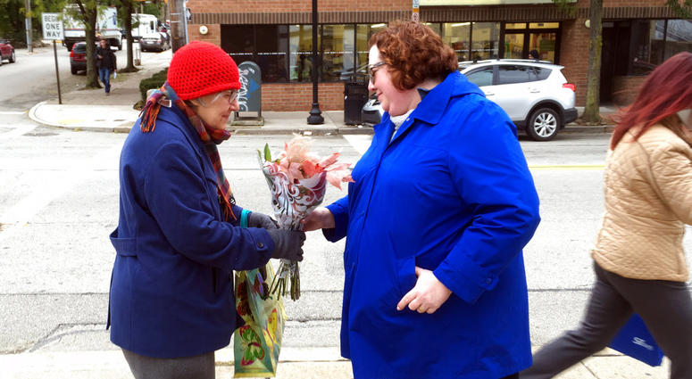 Kristin Wessell, right, hands a bouquet of flowers to Marianne Novy on Murray Avenue in the Squirrel Hill neighborhood of Pittsburgh, Monday, Oct. 29, 2018. Kristin Wessell, right, hands a bouquet of flowers to Marianne Novy on Murray Avenue in the Squirrel Hill neighborhood of Pittsburgh, Monday, Oct. 29, 2018.
