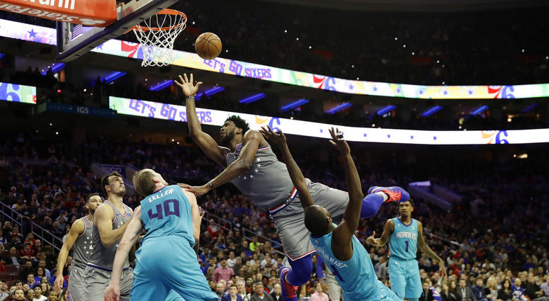 Philadelphia 76ers' Joel Embiid, tries to get a shot past Charlotte Hornets' Michael Kidd-Gilchrist, right, and Cody Zeller during the second half of an NBA basketball game, Friday, Nov. 9, 2018, in Philadelphia. Joel Embiid