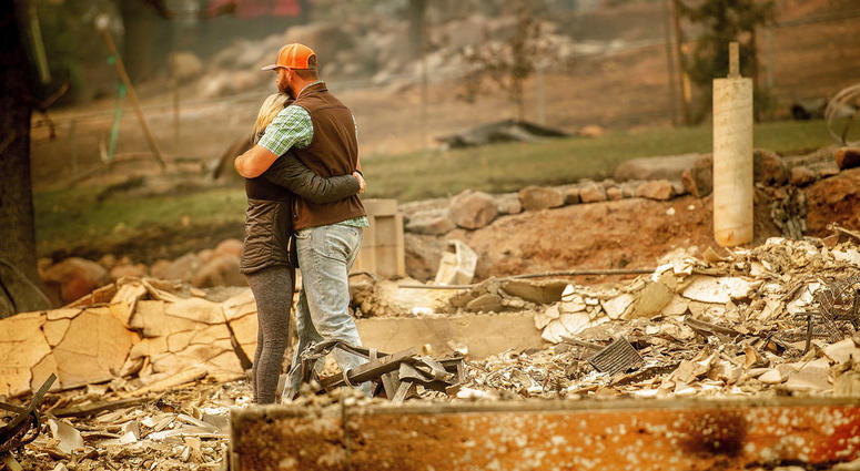 Chris and Nancy Brown embrace while searching through the remains of their home, leveled by the Camp Fire, in Paradise, Calif., on Monday, Nov. 12, 2018. As the fire approached, Nancy Brown escaped from the home with her 2-year-old and three dogs. Chris and Nancy Brown embrace while searching through the remains of their home, leveled by the Camp Fire, in Paradise, Calif., on Monday, Nov. 12, 2018.