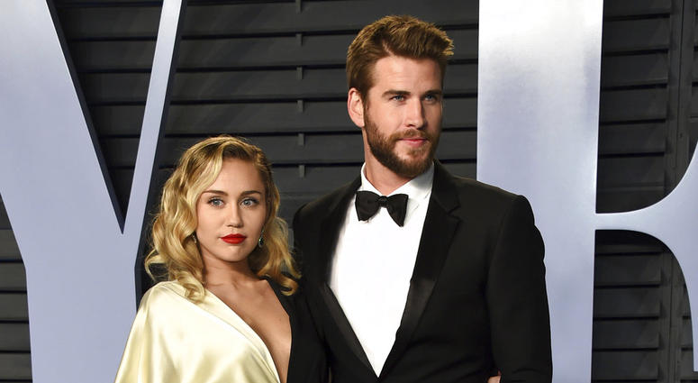 Miley Cyrus, left, and Liam Hemsworth arrive at the Vanity Fair Oscar Party in Beverly Hills, California, on March 4, 2018. Miley Cyrus and Liam Hemsworth