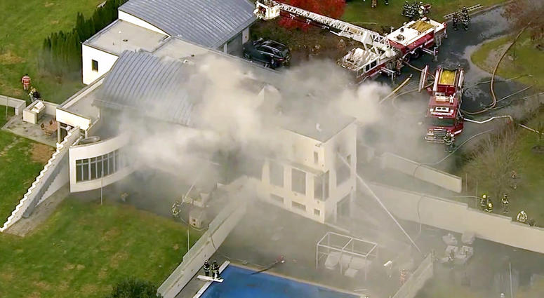 In this image made from a video provided by WABC firefighters battle a fatal fire on Tuesday, Nov. 20, 2018, in Colts Neck, N.J. The Monmouth County prosecutor's office says the fire has taken multiple victims. Deadly New Jersey Arson Fire