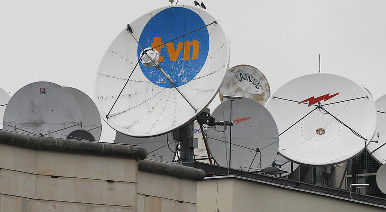 FILE - In this Sept. 12, 2017 file photo, satellite dishes sit on top of the headquarters of the TVN independent and popular TV network in Warsaw, Poland. FILE - In this Sept. 12, 2017 file photo, satellite dishes sit on top of the headquarters of the TVN independent and popular TV network in Warsaw, Poland.