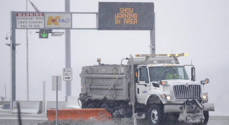 A plow removes snow at an entrance of the Kansas Turnpike near Lawrence, Kan., Sunday, Nov. 25, 2018. A plow removes snow at an entrance of the Kansas Turnpike near Lawrence, Kan., Sunday, Nov. 25, 2018.
