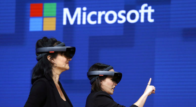 FILE- In this May 11, 2017, file photo, members of a design team at Cirque du Soleil demonstrate use of Microsoft's HoloLens device in helping to virtually design a set at the Microsoft Build 2017 developers conference in Seattle. FILE- In this May 11, 2017, file photo, members of a design team at Cirque du Soleil demonstrate use of Microsoft's HoloLens device in helping to virtually design a set at the Microsoft Build 2017 developers conference in Seattle.