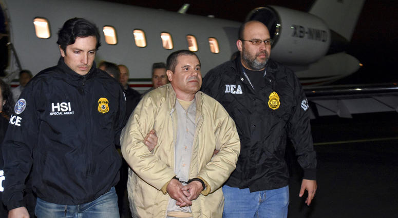 FILE - In this Jan. 19, 2017, file photo, provided by U.S. law enforcement, authorities escort Joaquin "El Chapo" Guzman, center, from a plane to a waiting caravan of SUVs at Long Island MacArthur Airport, in Ronkonkoma, N.Y. FILE - In this Jan. 19, 2017, file photo, provided by U.S. law enforcement, authorities escort Joaquin "El Chapo" Guzman, center, from a plane to a waiting caravan of SUVs at Long Island MacArthur Airport, in Ronkonkoma, N.Y.